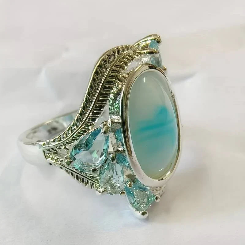 Turquoise ring voor dames met ovale steen en bladmotief, zilverkleurig vintage sieraad in ringmaat 52 tot 62 | Covesville