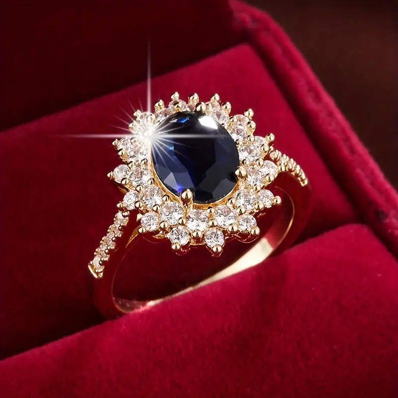 Ring met blauwe steen omringd door glinsterende steentjes, damesring in goud of zilver, ringmaat 50 tot 62 | Covesville